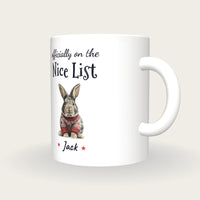 Personalised Christmas Jumper Rabbit Mug, On The Nice List, three-quarter view