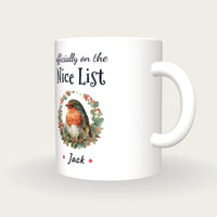 Personalised Robin In A Wreath Mug, On The Nice List, three-quarter view