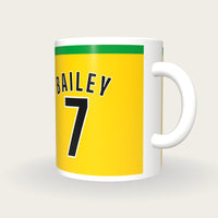 Personalised Gold and Black Football Shirt Mug, three-quarter view